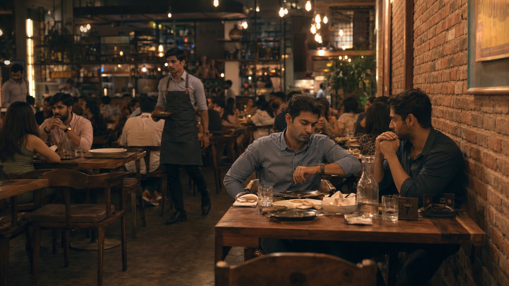A guest at Table 7 waiting, plates pushed aside